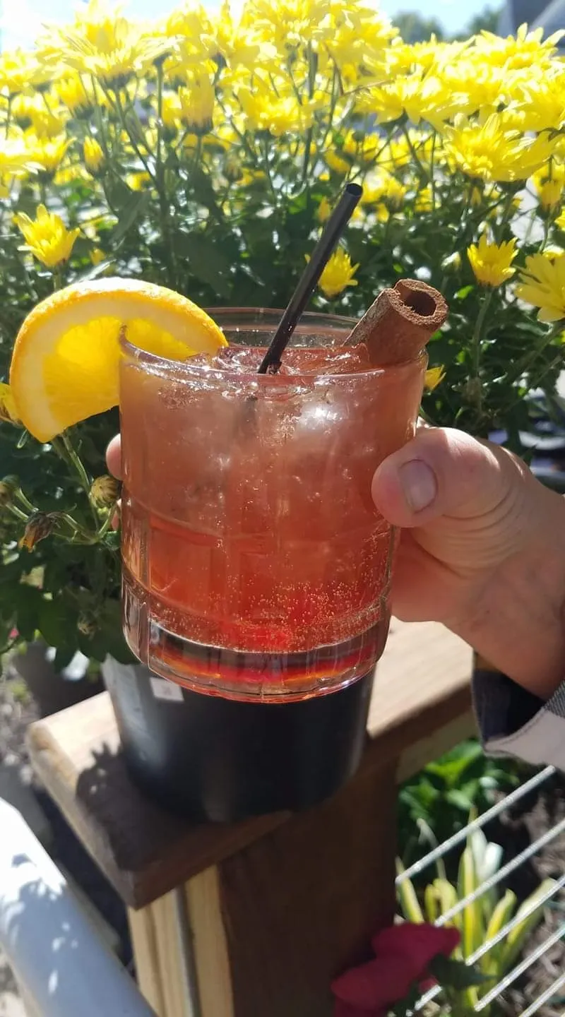 A brandy old fashioned garnished with orange and cinnamon